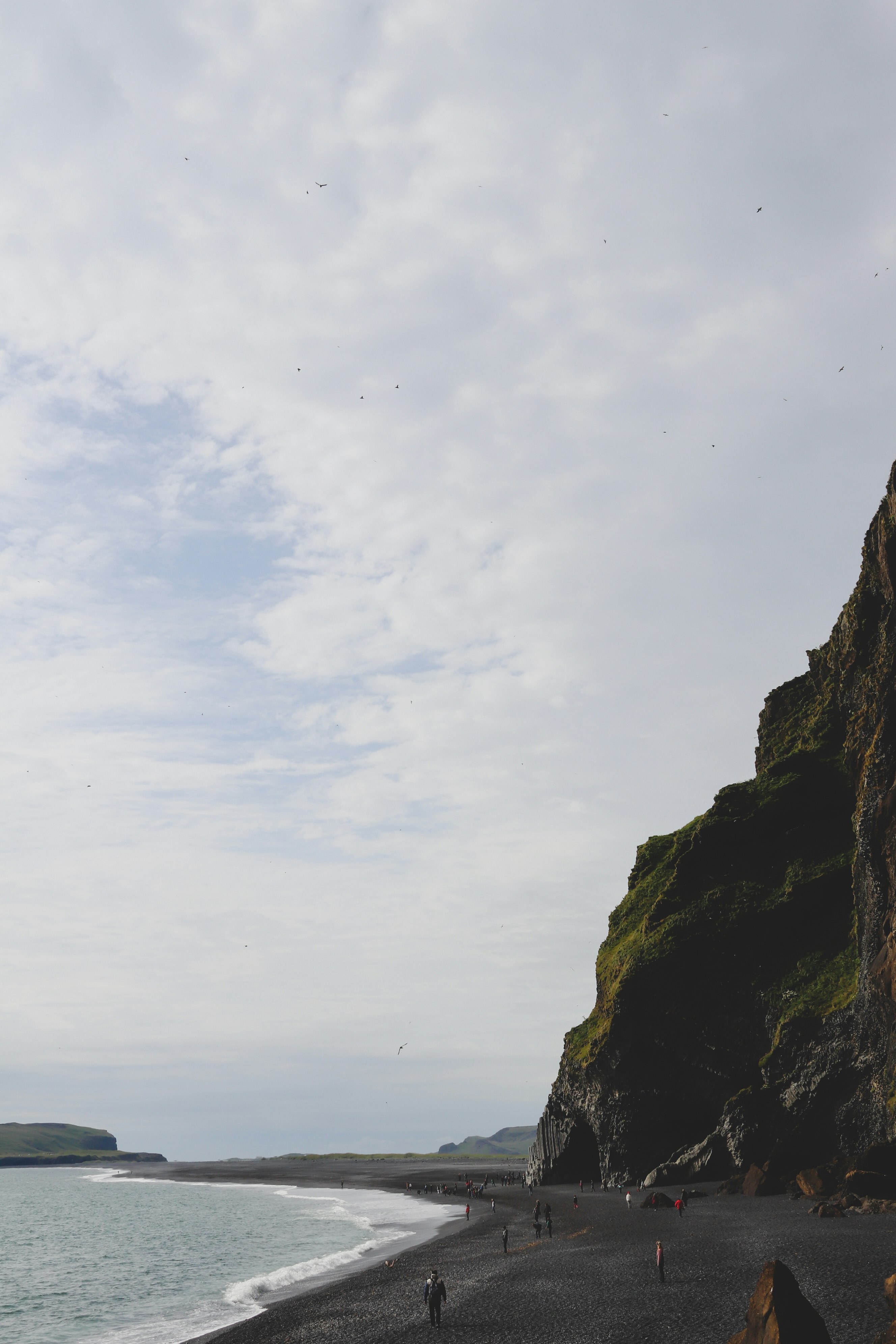 brown rock formation under white clouds during daytime